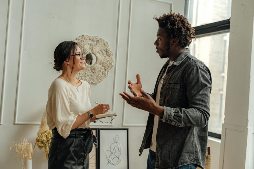 A man and woman engaging in a professional consultation in a stylish office setting, highlighting collaboration.