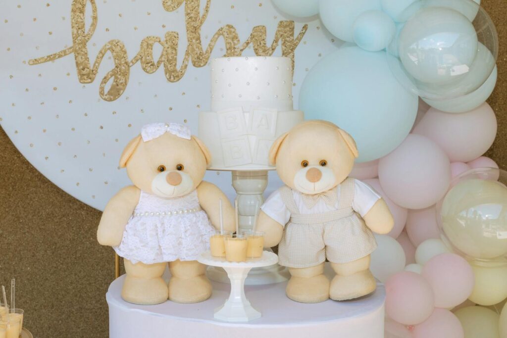 Elegant baby shower setup with teddy bear decorations and pastel balloons, perfect for gender reveal parties.