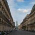 View of the historic Colonne Vendôme in Paris with classic architecture and street life.