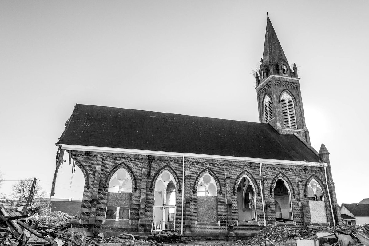 Black and white photo of a partially demolished Gothic Revival church in Columbus, Indiana.