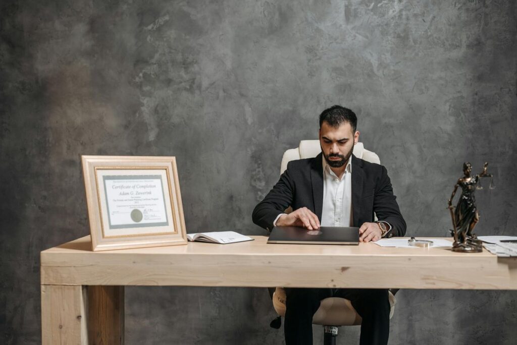 A bearded lawyer working at his office desk, showing professionalism and expertise.
