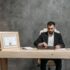 A bearded lawyer working at his office desk, showing professionalism and expertise.