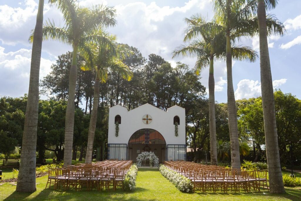 Beautiful outdoor wedding setting with palm trees and a chapel in São Paulo, Brazil.