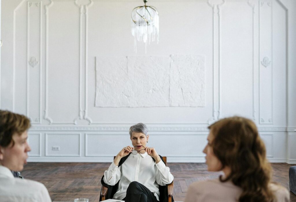 A therapist guiding a couple through a counseling session in an elegant office setting.