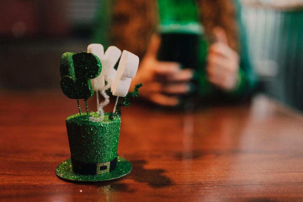 Close-up of St. Patrick's Day decor with a green beer in the background, celebrating the holiday spirit.