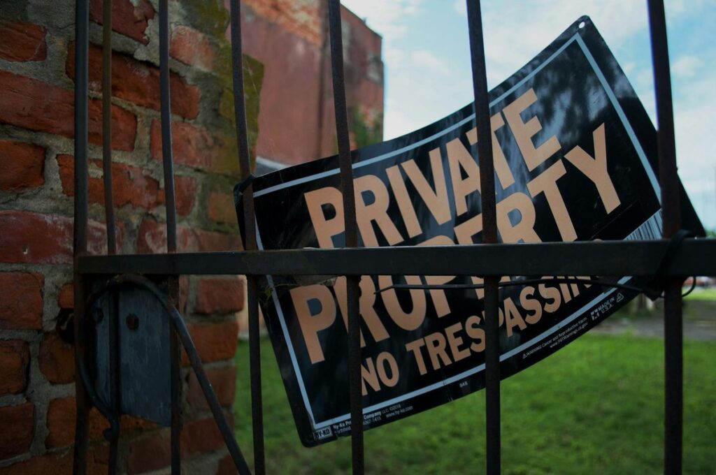 Two professionals in a law office discussing legal documents. Indoor setting with American flag decor.