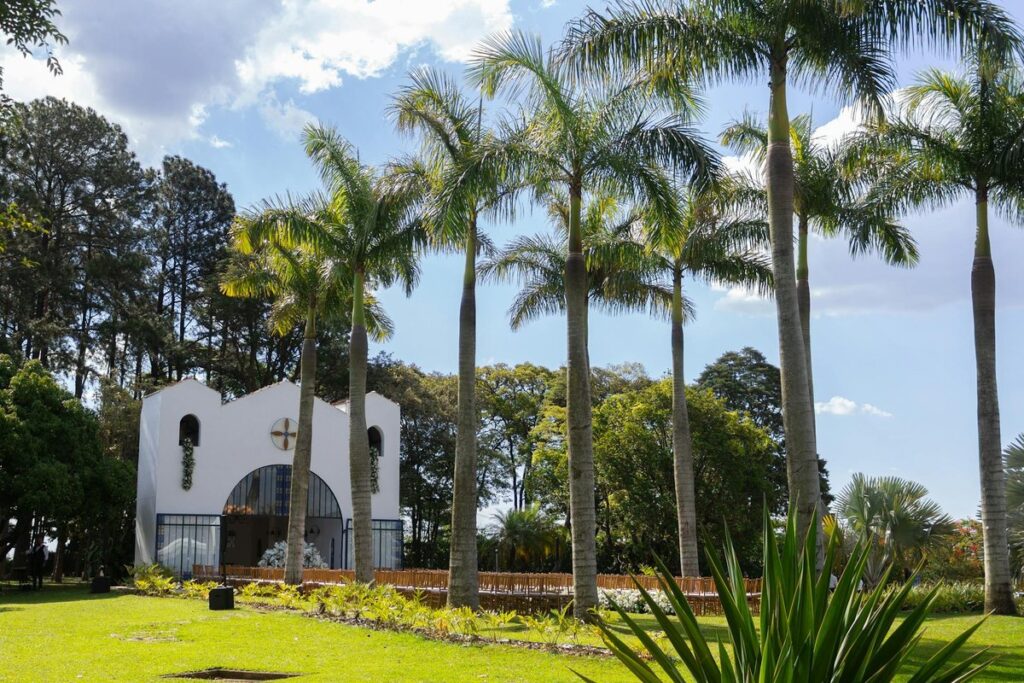 Beautiful garden wedding setup with palm trees at a chapel in São Paulo, Brazil.