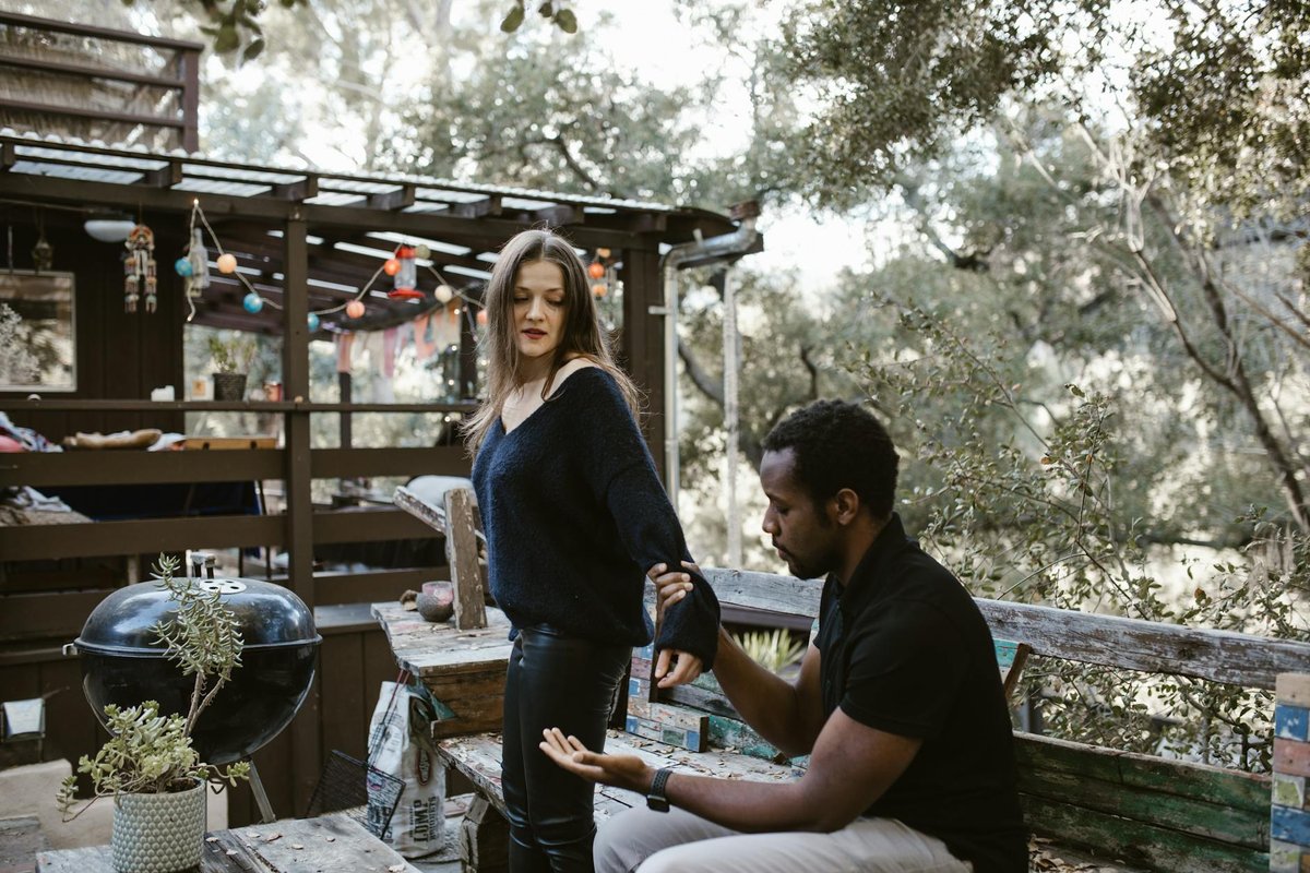 Tense encounter between a couple on a rustic patio.