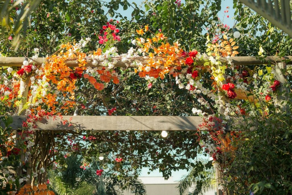 Colorful flowers adorning an outdoor arbor, perfect for weddings or garden celebrations.