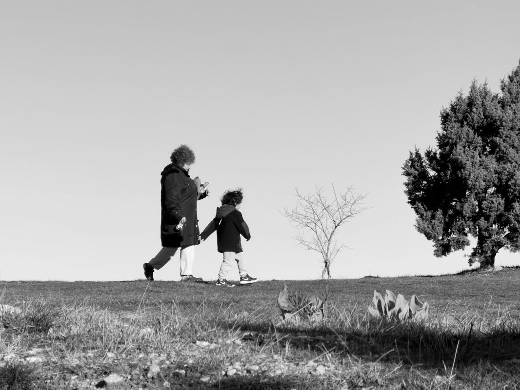 Woman and Child Walking Together in Nature (Black and White)