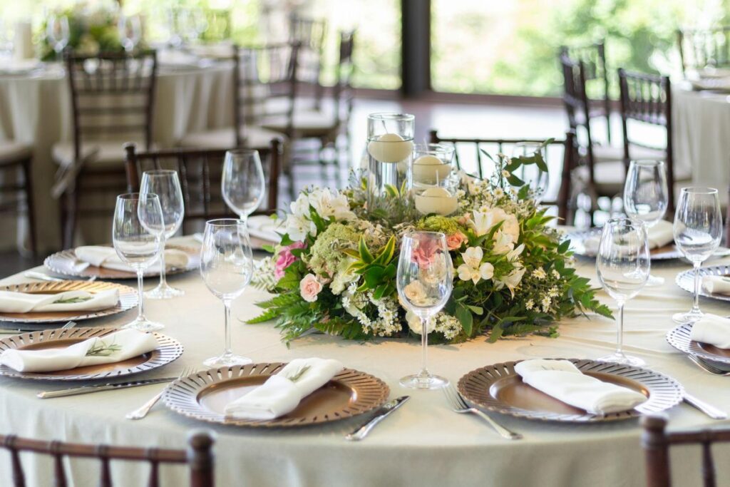 Chic wedding table setting with elaborate floral centerpiece and fine tableware, perfect for sophisticated events.