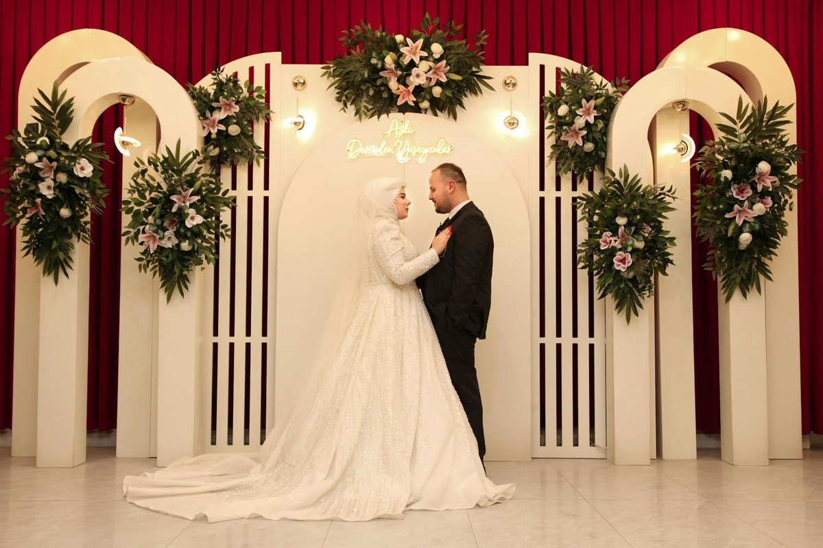 Bride and groom pose gracefully in an elegant wedding decor setup.