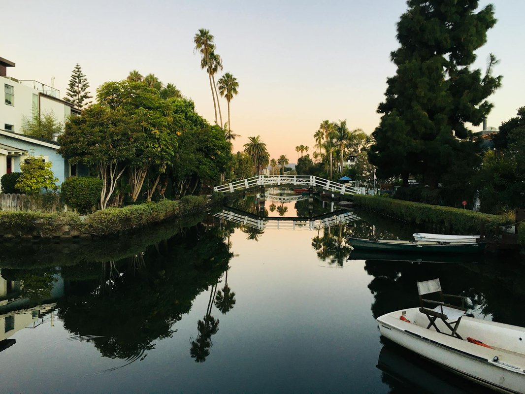 Serene view of the Venice Canals with a tranquil reflection at sunset.