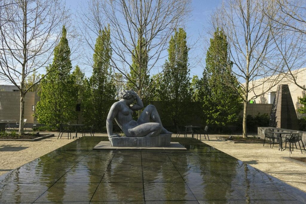 Peaceful garden with a sculptural statue in Columbus, Ohio, showcasing serene landscape design.