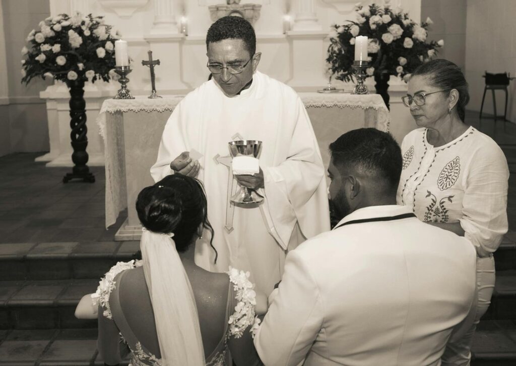 A priest performing a wedding ceremony inside a church.
