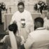 A priest performing a wedding ceremony inside a church.