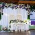 Beautifully decorated outdoor wedding venue with floral arches and chairs.
