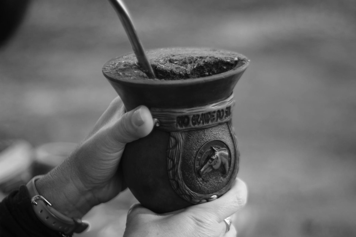 Close-up of hands holding a gourd with mate tea in Porto Alegre, Brazil.