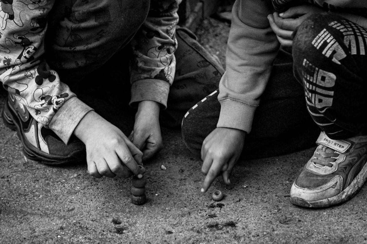 Black and white photo of children playing a traditional game in Istanbul.