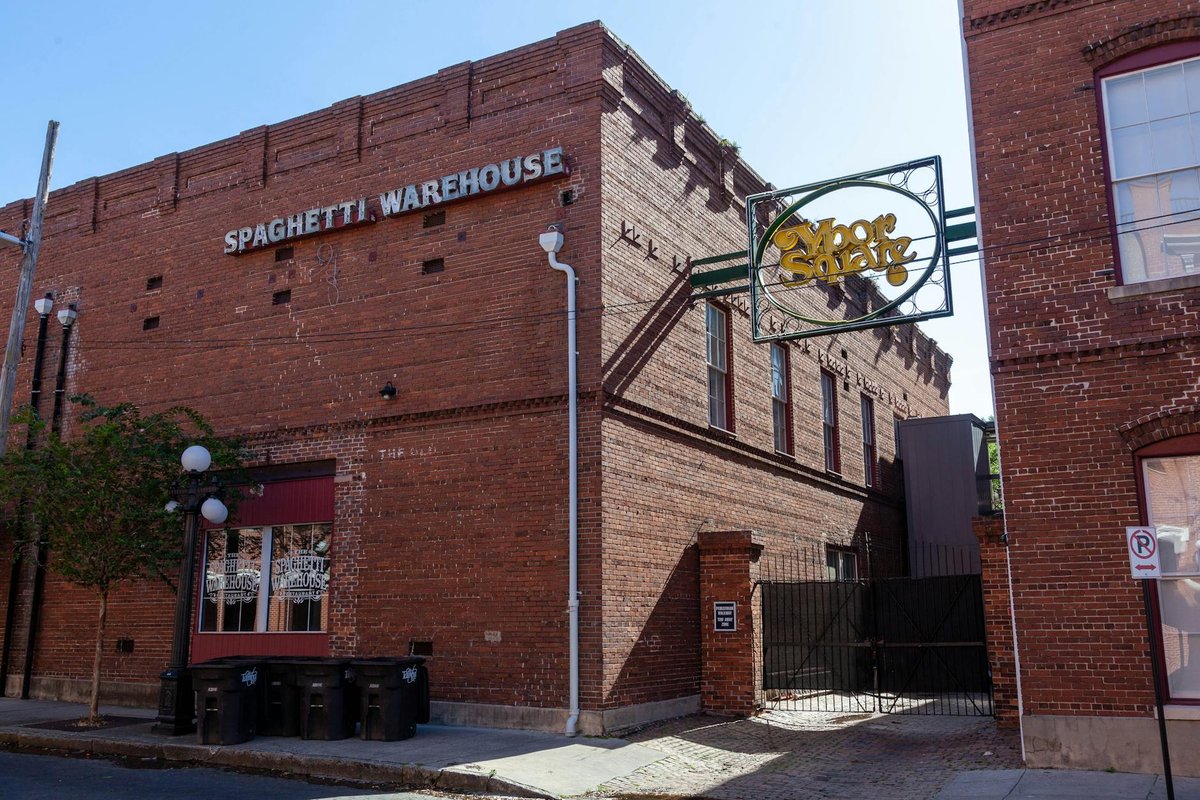 A classic brick Spaghetti Warehouse building with urban architecture and signage.