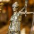 A detailed close-up of a Lady Justice statue holding scales, symbolizing law and justice.