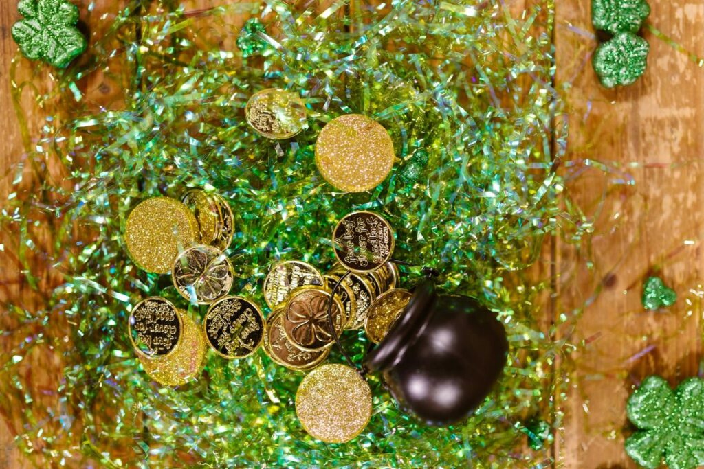 Colorful St. Patrick's Day scene with gold coins, shamrocks, and festive tinsel.
