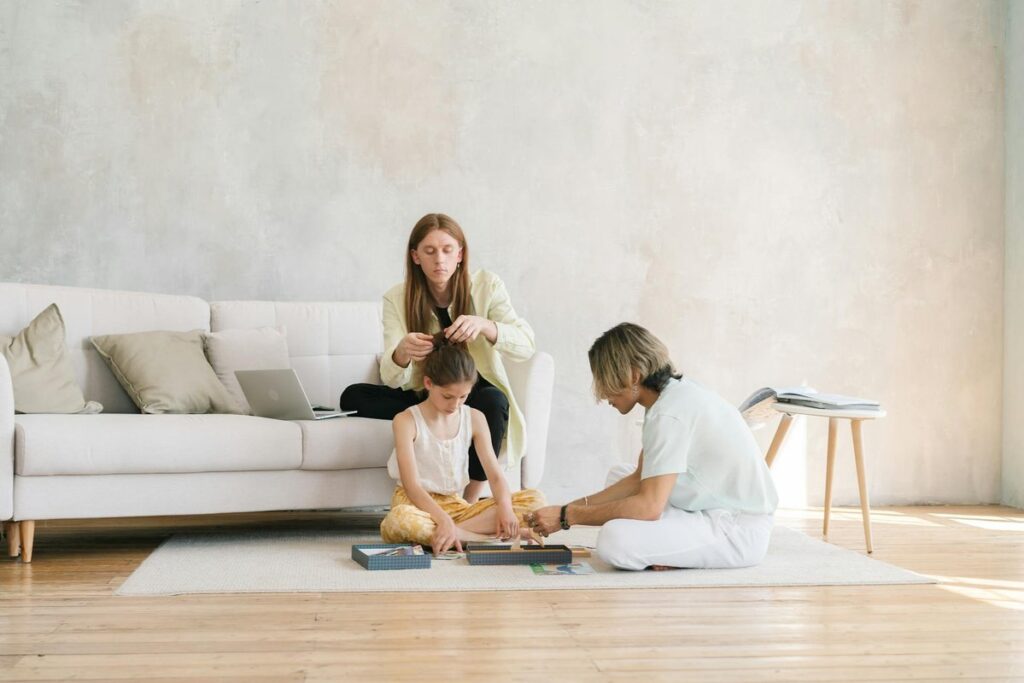 A family enjoying quality time together indoors, playing and bonding in a cozy living room.