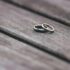 Elegant two-tone wedding rings on rustic wooden surface, symbolizing love and unity.