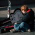 A child sits with a guitar case in Dublin, capturing the essence of street performance.