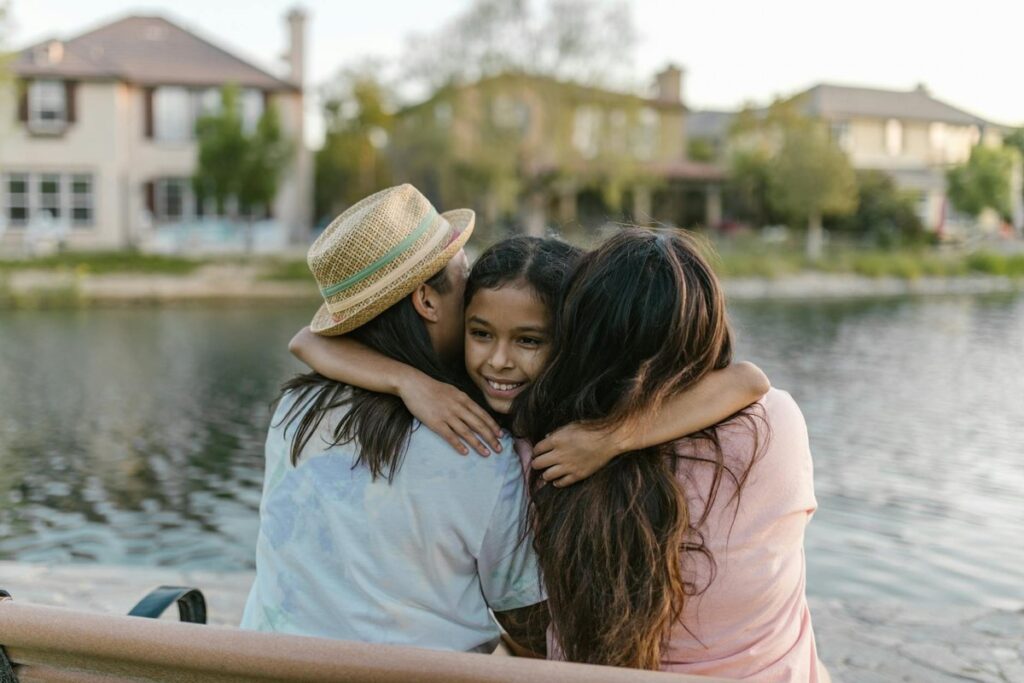 A heartwarming family moment by the lake, showcasing love and togetherness.