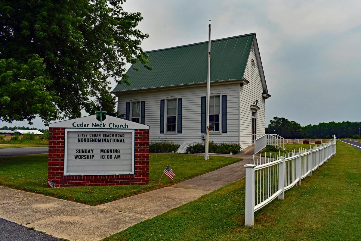 Nondenominational Cedar Neck Church with green roof, photographed on a cloudy day in Delaware.