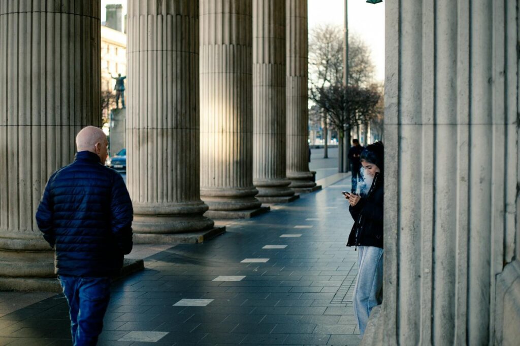 Street photography with people and classical pillars in County Dublin, Ireland.