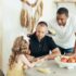 A diverse family enjoying a moment together around the dining table at home.