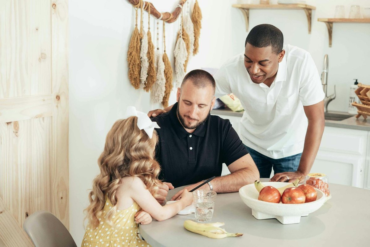 A diverse family enjoying a moment together around the dining table at home.