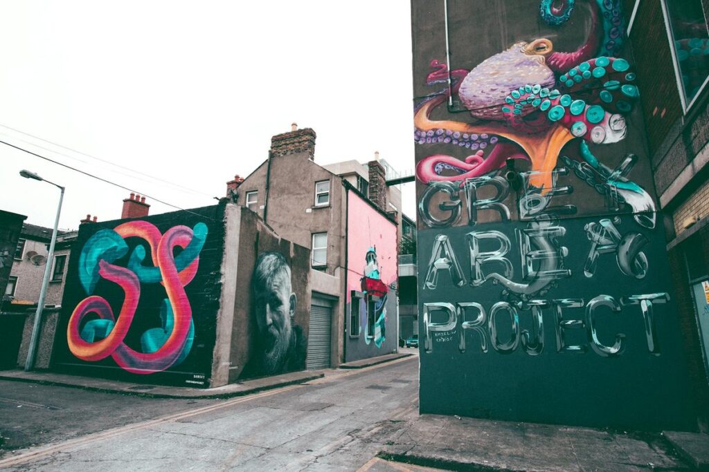 Colorful graffiti art in Dublin's alleyway, featuring abstract designs and cultural murals.