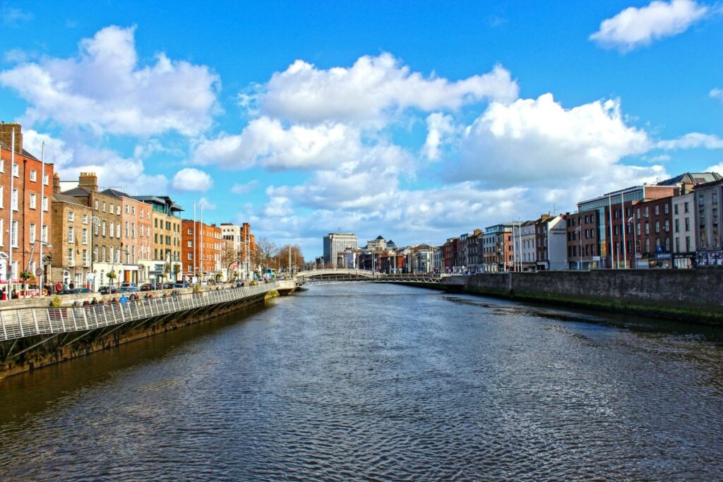 Beautiful daytime view of the River Liffey flowing through Dublin, Ireland, with iconic city buildings.