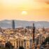 A stunning sunset view of the Barcelona skyline showcasing iconic landmarks and a warm, golden hour glow.