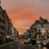 Vibrant city street in Dublin, Ireland during a stunning sunset, showcasing urban life.