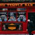 Iconic Temple Bar in Dublin, featuring its vibrant red facade on a bustling city street.