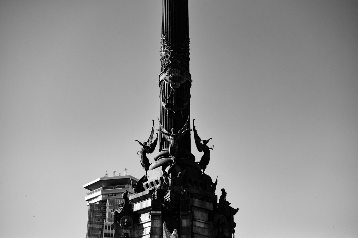 Black and white photo of Columbus Monument in Barcelona highlighting its intricate details.