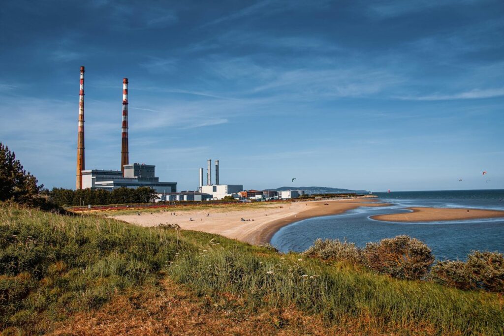 View of Poolbeg Chimneys and Sandymount Beach in Dublin, Ireland on a sunny day.